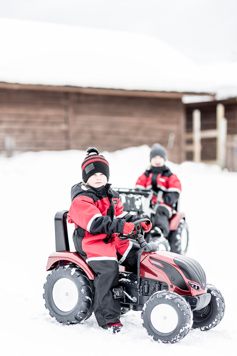 Kid playing with Backhoe loader pedal Valtra 4000AM