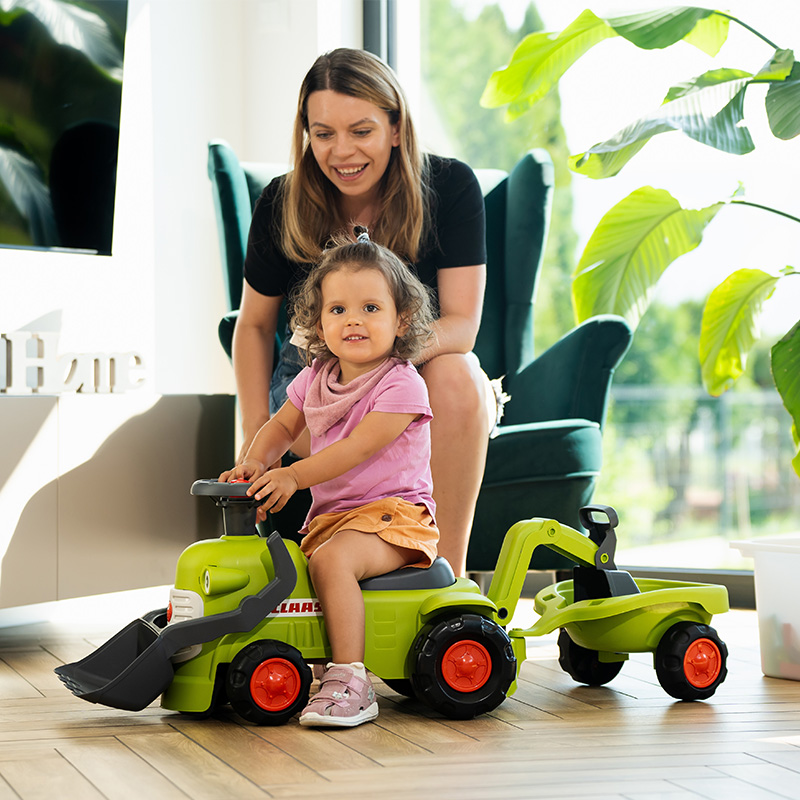Kid and parent with Ride-on Tractor CLAAS